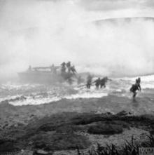 THE BRITISH ARMY IN THE UNITED KINGDOM 1939-1945 (H 14597) Troops coming ashore from a landing craft under a smoke screen during Combined Operations training at Inveraray, Scotland. Copyright: © IWM. Original Source: http://www.iwm.org.uk/collections/item/object/205214998